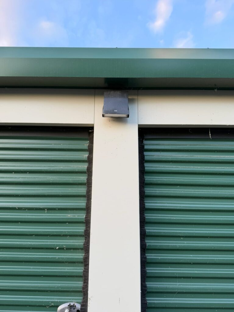 Storage unit door frame after professional spider web removal in Waterville, Maine