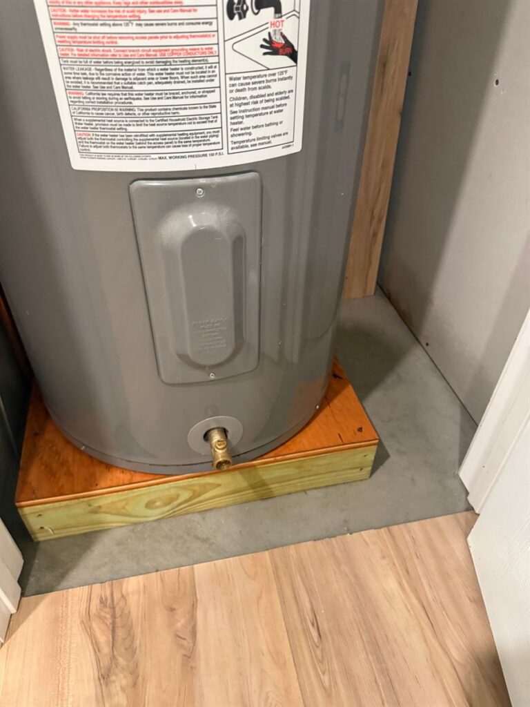 Clean water heater closet floor after rodent cleanup and sanitation by Northern Pest Solutions in Central Maine